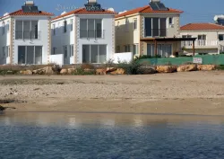 Beachfront villa in Ayia Napa resort area with large swimming pool and sandy beach access